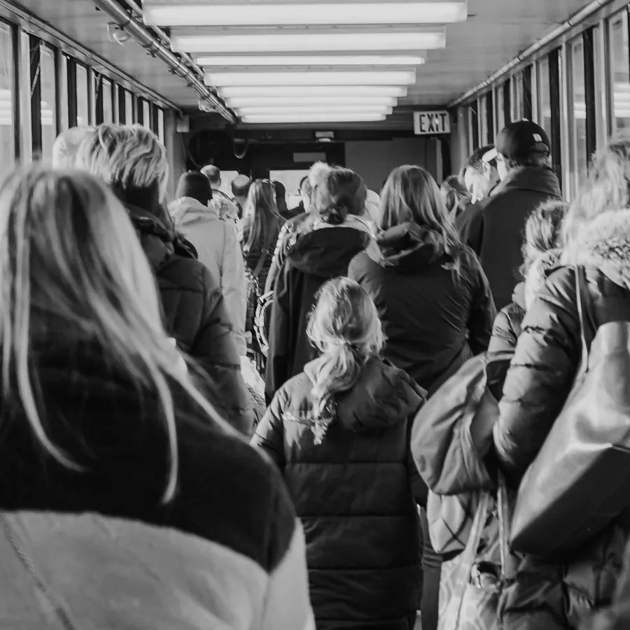 Person seen from behind in a queue, blurred surroundings