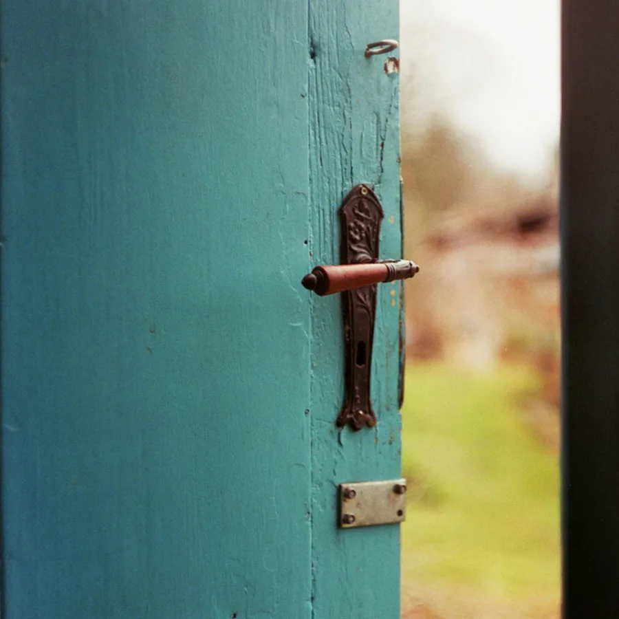 A door ajar letting in the light from outside