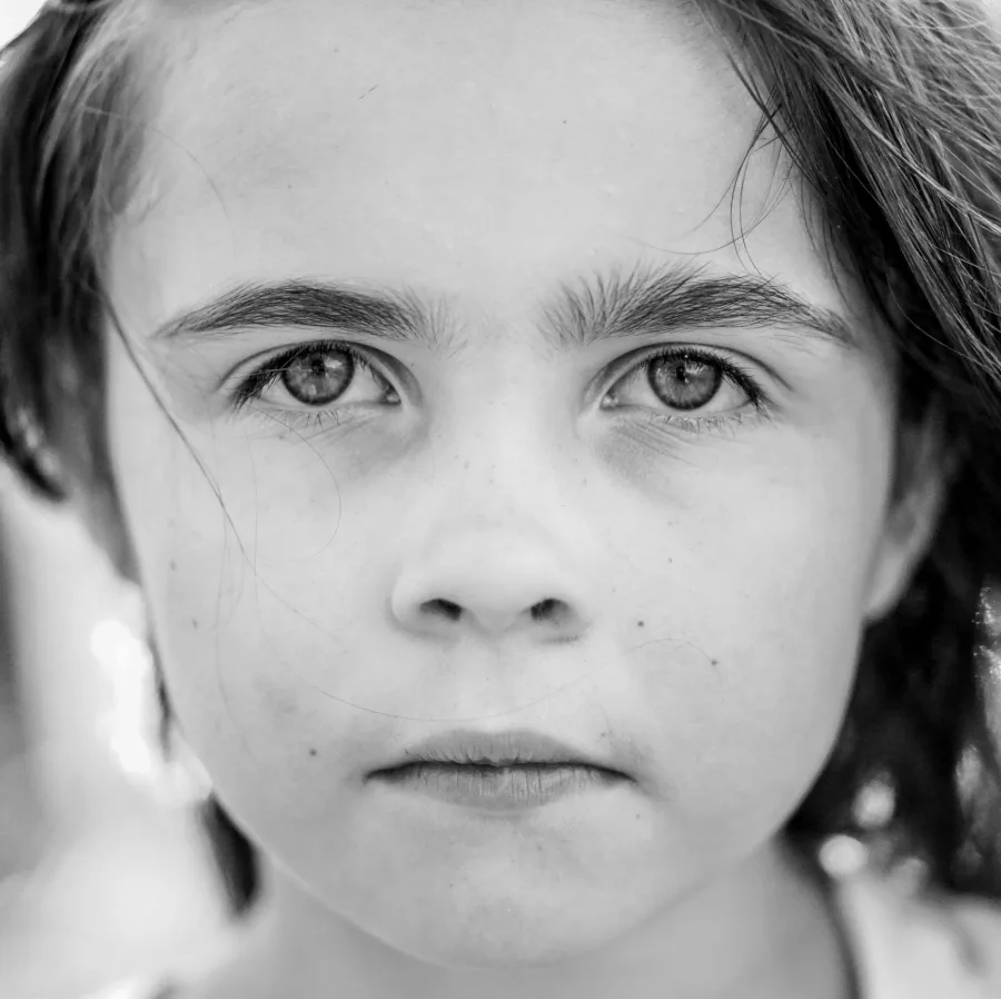Black and white portrait of a child with a serious expression