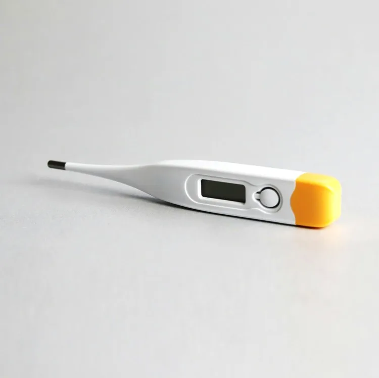 Digital thermometer resting on a pale surface