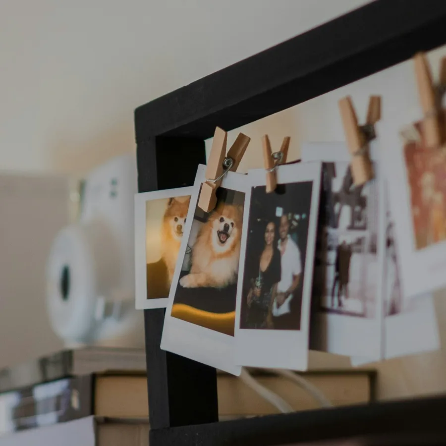 Polaroid photographs hanging from a line on clothes pegs