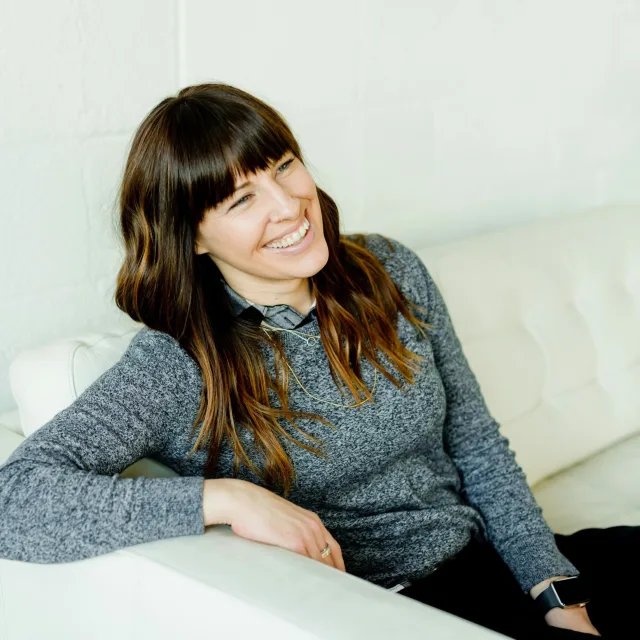 Smiling, relaxed woman sitting comfortably