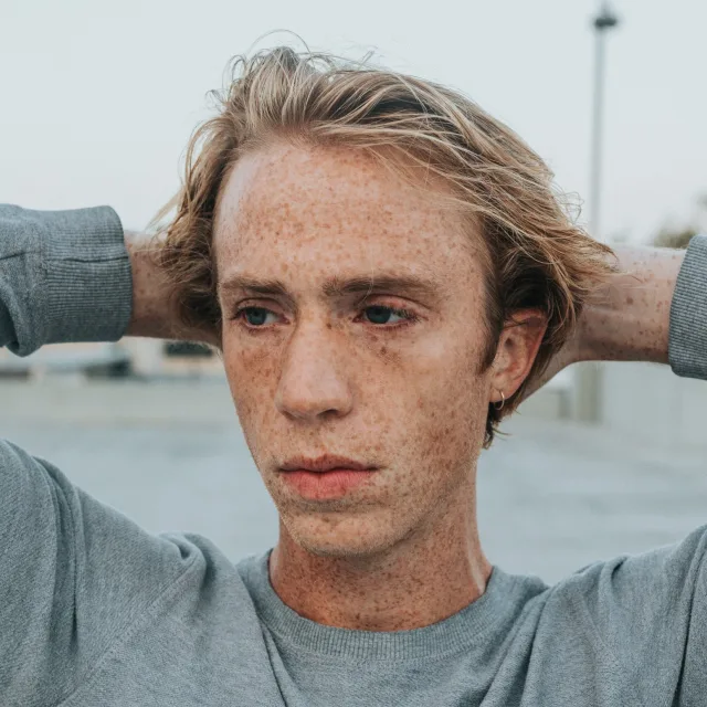 Young man with a bare, exposed face and an intense gaze