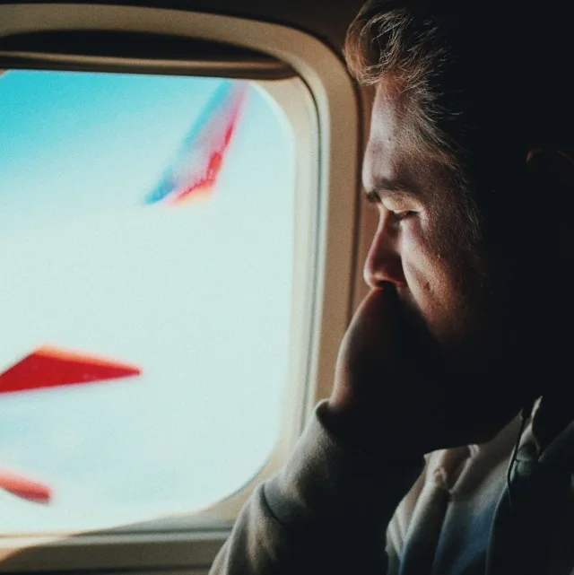 Anxious passenger looking at the aircraft wing through the window